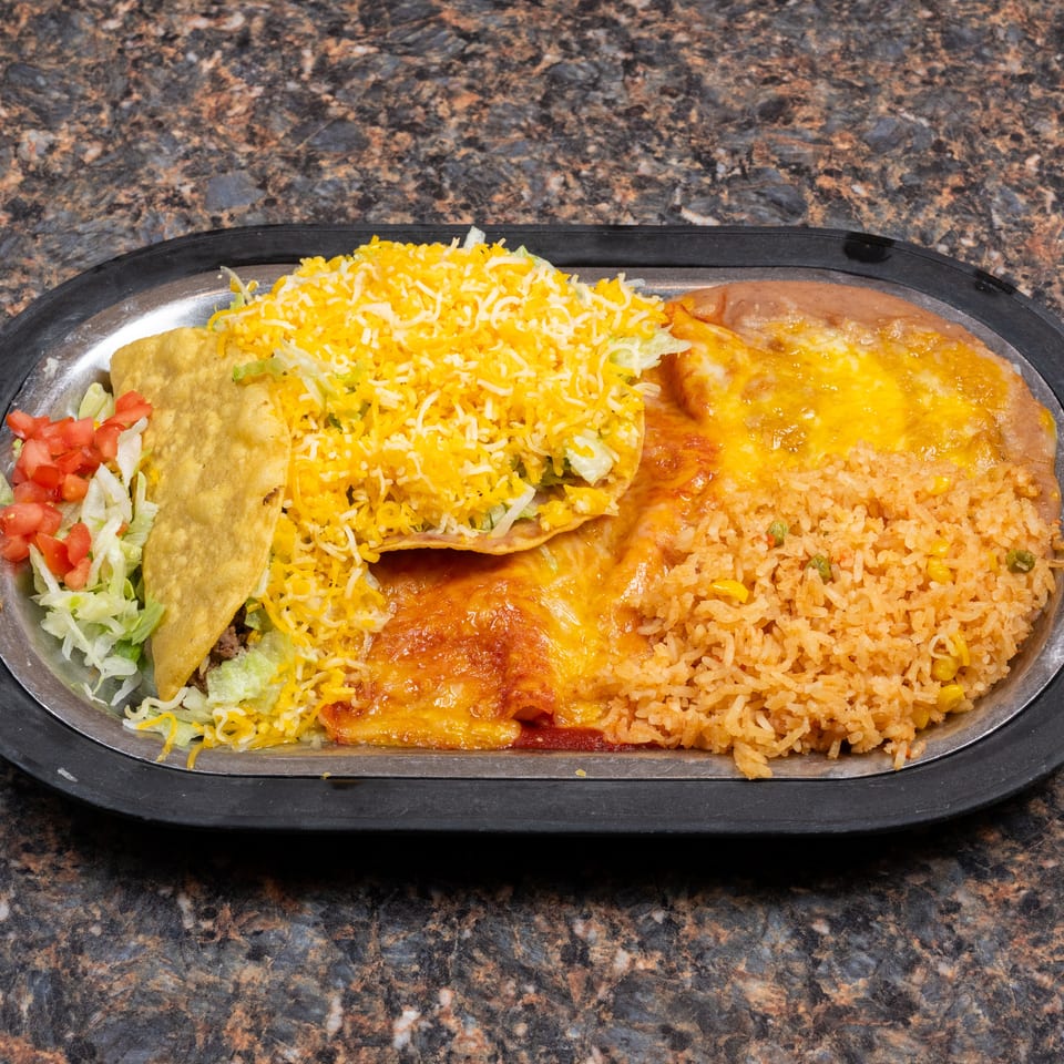 Mexican combination platter with cheese-covered enchiladas, a crispy taco, refried beans, Spanish rice, lettuce, and diced tomatoes.